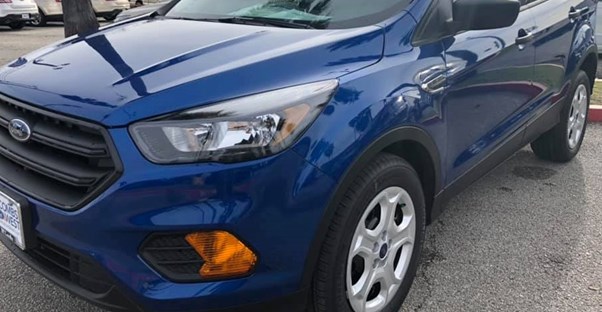 a blue 2019 ford escape parked on a car lot