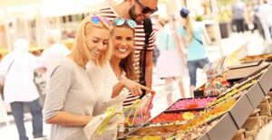 Three people at a farmers market