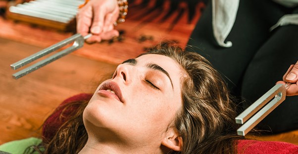 Woman trying out a holistic medicine treatment to treat her pain.