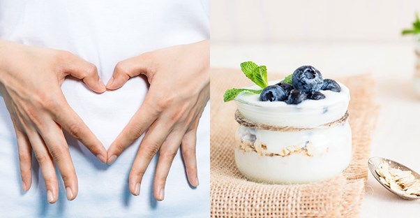 woman making heart with hands on stomach and blueberry yogurt