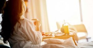 woman staring from hotel room