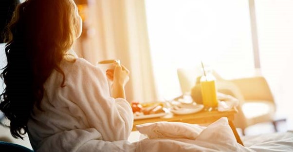 woman staring from hotel room