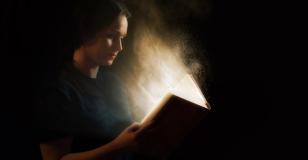 A girl reads the wild events happening in the Bible.