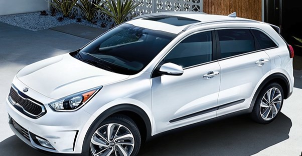 a white 2019 kia niro sitting in a driveway