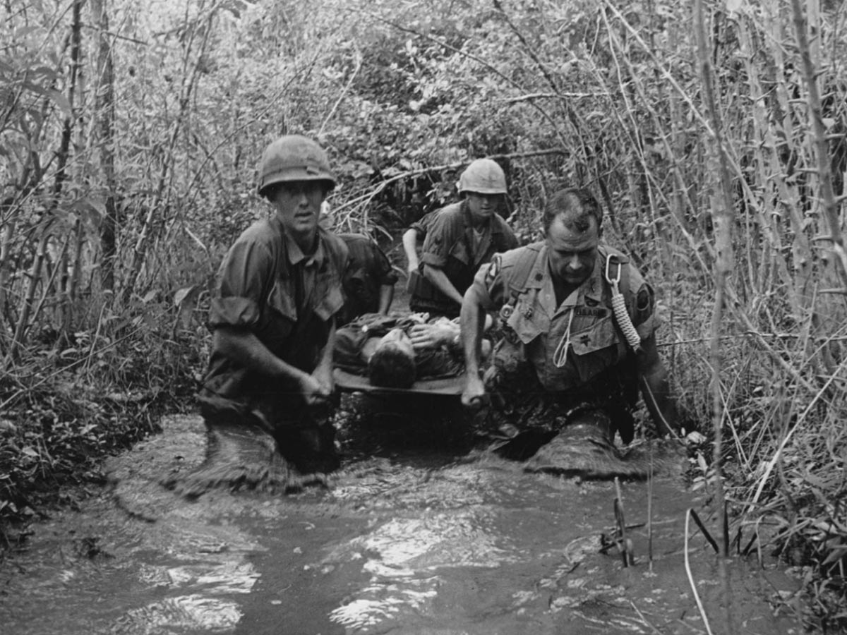 Carrying Wounded Soldier Through Swamp