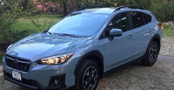 a new blue gray 2019 subaru crosstrek parked in a driveway