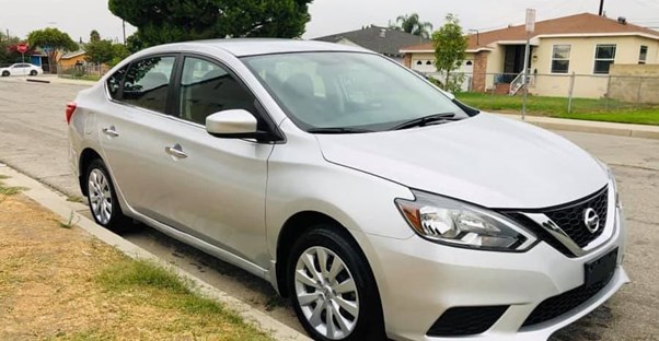 a 2019 silver nissan sentra parked on a residential street