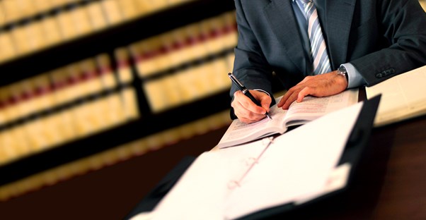 Man taking notes and studying legal terms