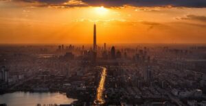 the tall buildings of a city in front sunset