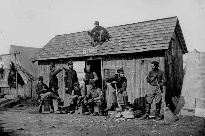 Soldiers in Front of Their Wooden Hut