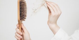woman losing her hair and hair products