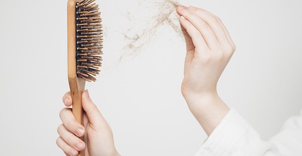 woman losing her hair and hair products