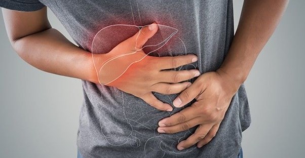Photo of man holding stomach