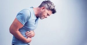 Photo of man holding abdomen