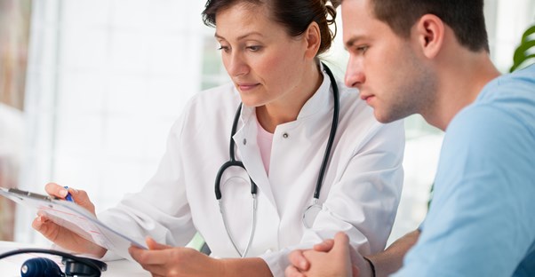 a doctor examines a blood sugar test with a patient