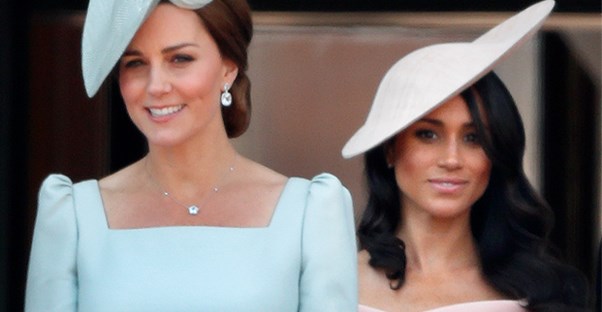 Kate Middleton and Meghan Markle standing side by side
