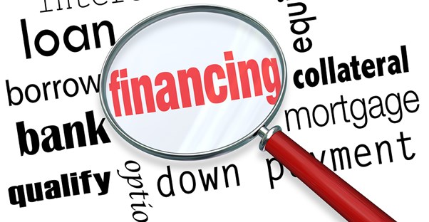 Word cloud with magnifying glass highlighting financing