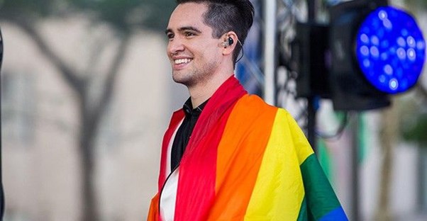Panic! At the Disco front man Brendon Urie with a gay pride flag wrapped around his shoulders