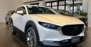 a white 2021 mazda cx-30 in a dealership showroom