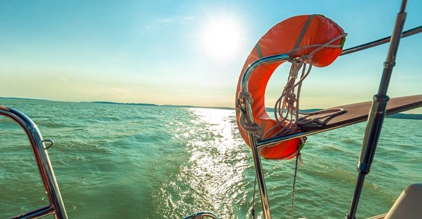 Person traveling abroad on a boat who definitely needs international travel insurance