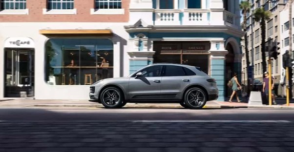 a gray 2021 porsche macan parked along a city street