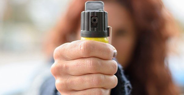 woman spraying pepper spray