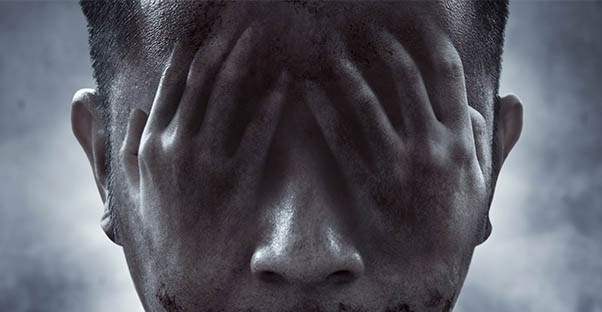 scary picture of a guy with hands over eyes