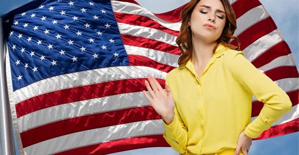 smug woman in front of flag