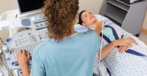 a doctor examining a patient for hyperthyroidism