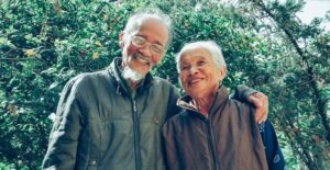 happy older couple hugging and smiling