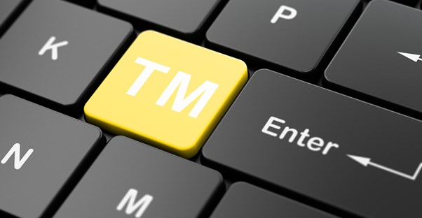 a key on a keyboard labeled with the trademark symbol
