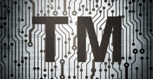 they trademark symbol over a stylized computer chip circiutry background