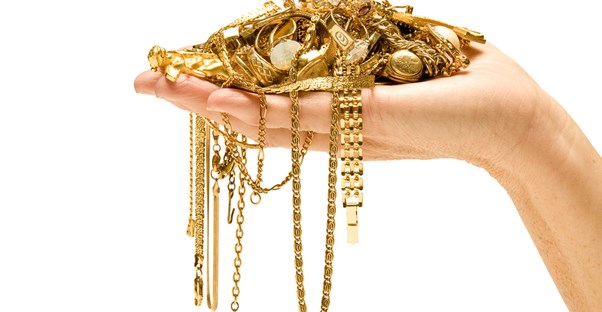 a handful of gold with varying karat values