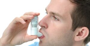 a man tries out his clear inhaler to combat his asthma