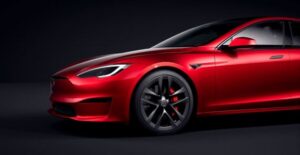 A Red 2024 Tesla Model S on a Black Backdrop
