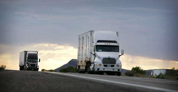trucks being operated by two drivers who found truck driving jobs