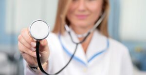 a medical assistant holding a stethoscope