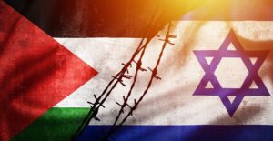 The Palestine and Israel flags separated by barbed wire