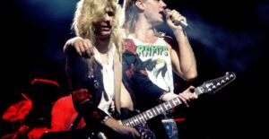 two members of def leppard on stage performing