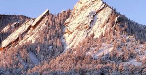 the snow covered flatirons of colorado