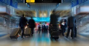 a departure gate with business class passengers walking toward the airline gates