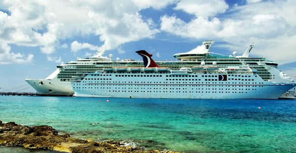 a cruise ship sitting just off shore in the ocean