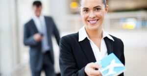 a flight attendant hands the viewer a business class boarding pass