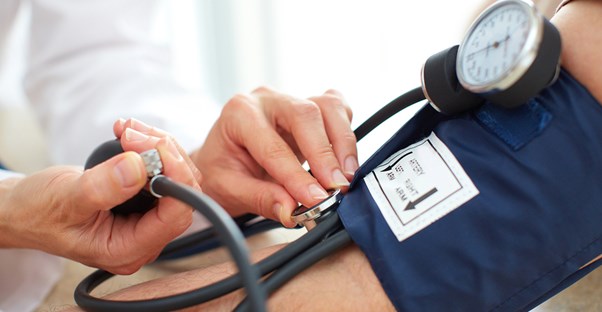 a doctor examining a patient for symptoms of hypertension