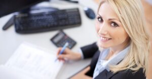 Woman smiles after hiring payroll service