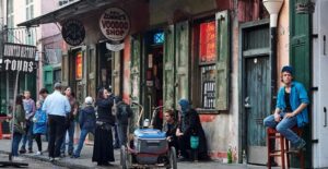 people stand along bourbon street in new orleans louisiana