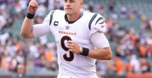 the starting quarterback for the Cincinnati Bengals running off the football field