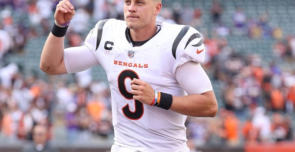 the starting quarterback for the Cincinnati Bengals running off the football field
