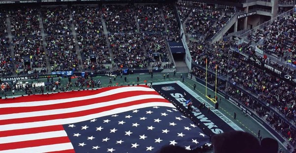 a flag stretched across the field of a super bowl game