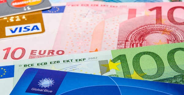 colorful travel credit cards and foreign bank notes